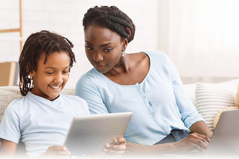 Mother using caution while daughter is on laptop.